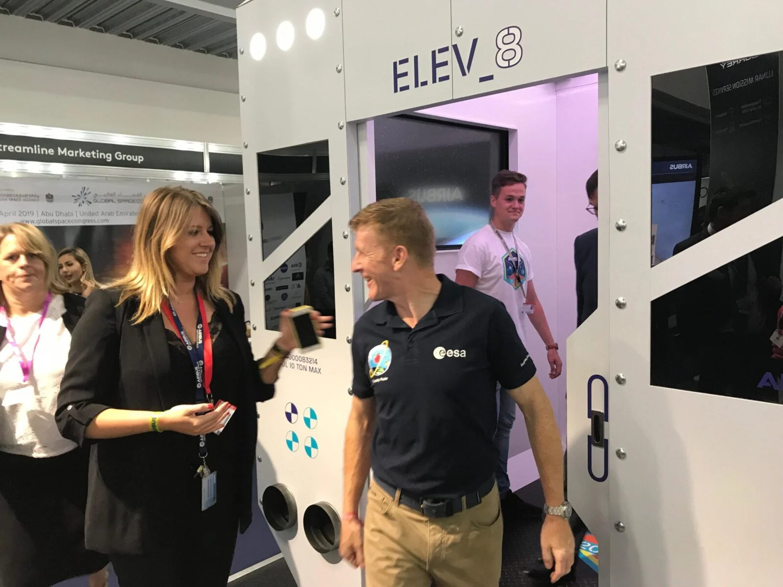 Exhibition visitors standing outside the entrance to the Airbus ELEV8 cabin.