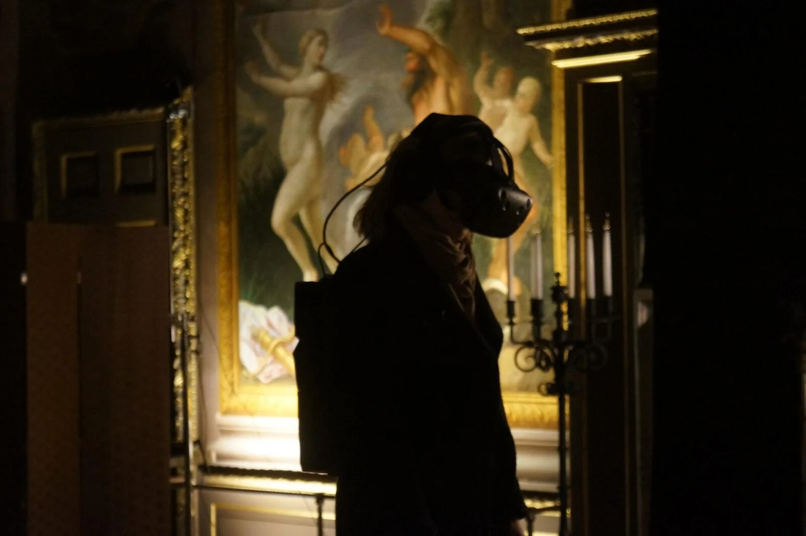 Visitor wearing a VR headset in an ornate historic room during Pleasure Palace.