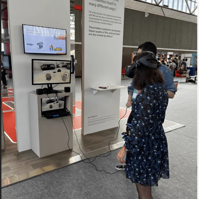 Roche exhibition participant using a virtual reality headset and hand controllers.