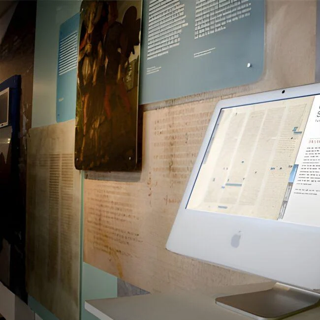 Codex Sinaiticus interactive display on a white computer in a museum gallery.