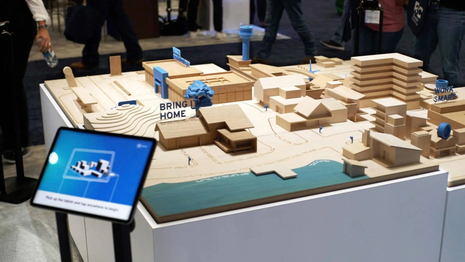 Wooden model city and tablet interface on the GM Energy augmented reality table.