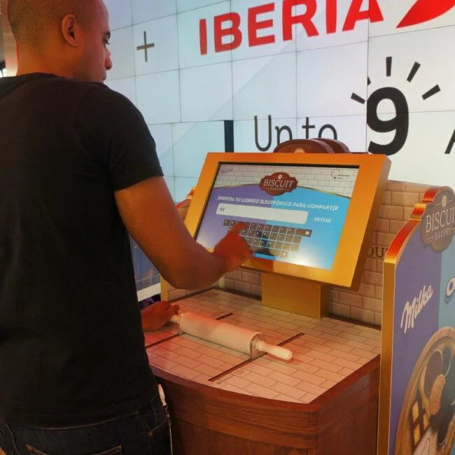 Visitor using a bakery-themed touchscreen kiosk at a Mondelez retail activation.