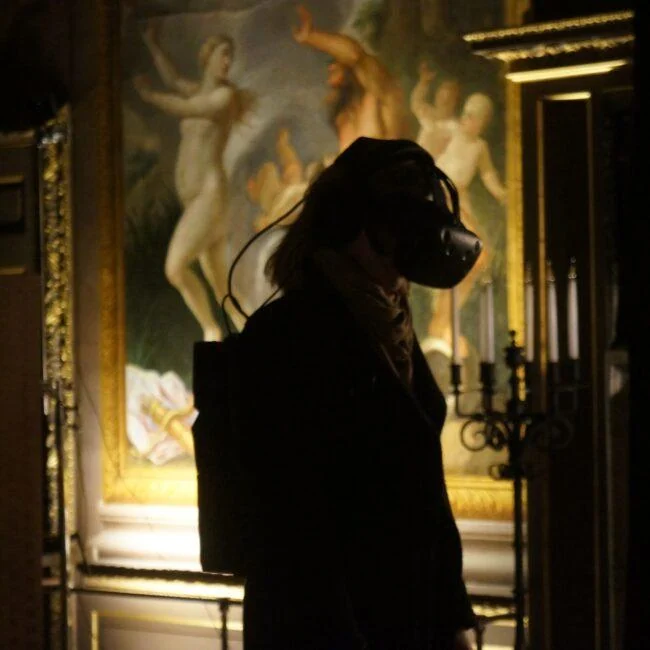 Visitor wearing a VR headset in an ornate historic room during Pleasure Palace.