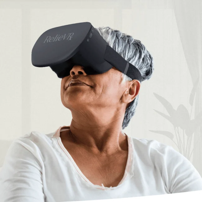 Seated participant wearing a black RelieVRx virtual reality headset.