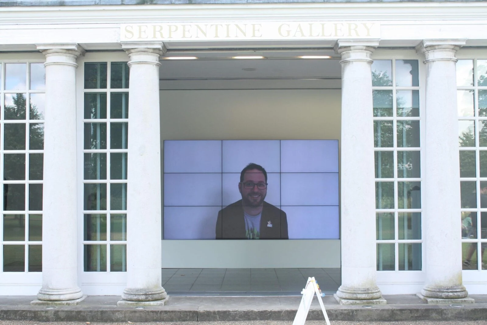 Smiles Film video wall framed by the entrance columns of the Serpentine Gallery.